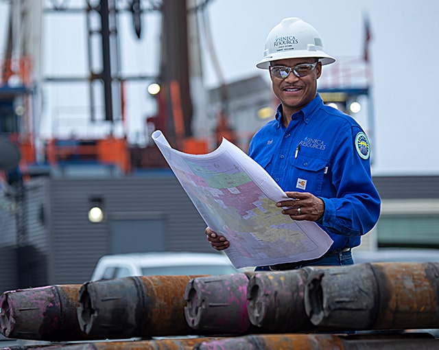 worker in hard hat with plans