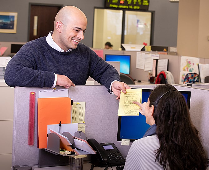 office workers discussing notes