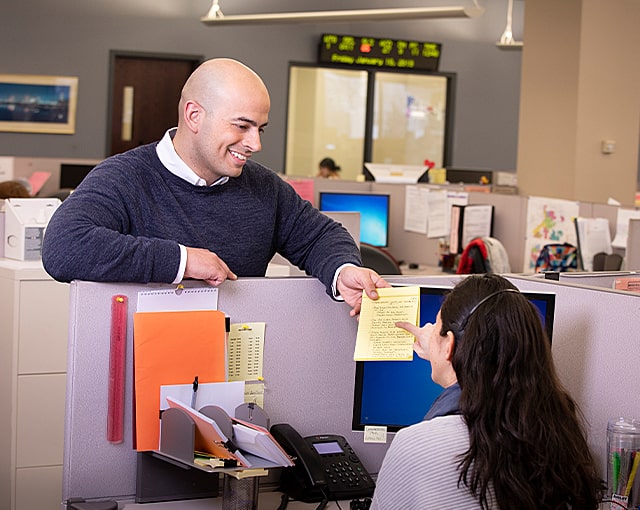 office workers discussing notes