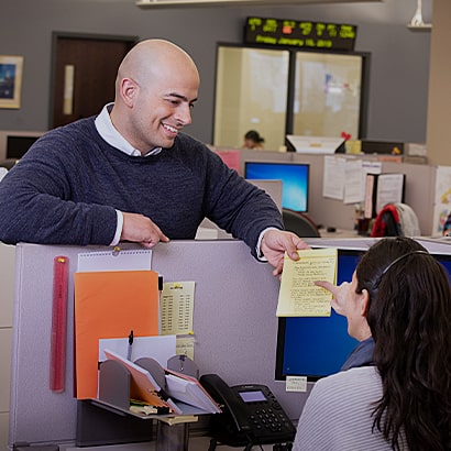 office workers discussing notes