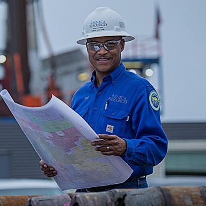 worker reviewing large planning document