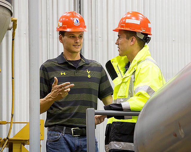 two workers discussing plans