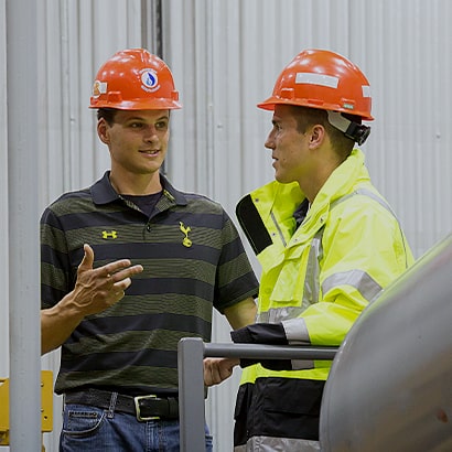 two workers discussing plans