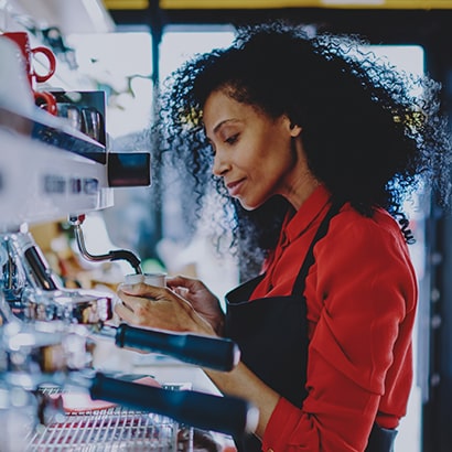 coffeeshop worker making latte