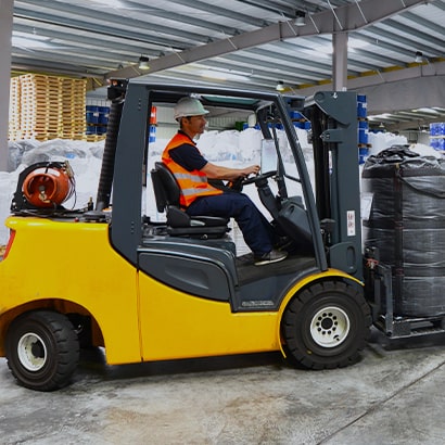 worker driving forklift