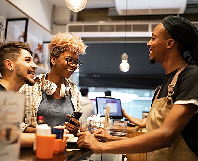 three smiling people at coffee shop