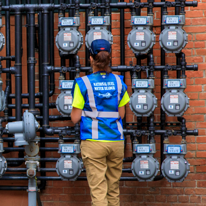 woman meter reader looking at multiple meters