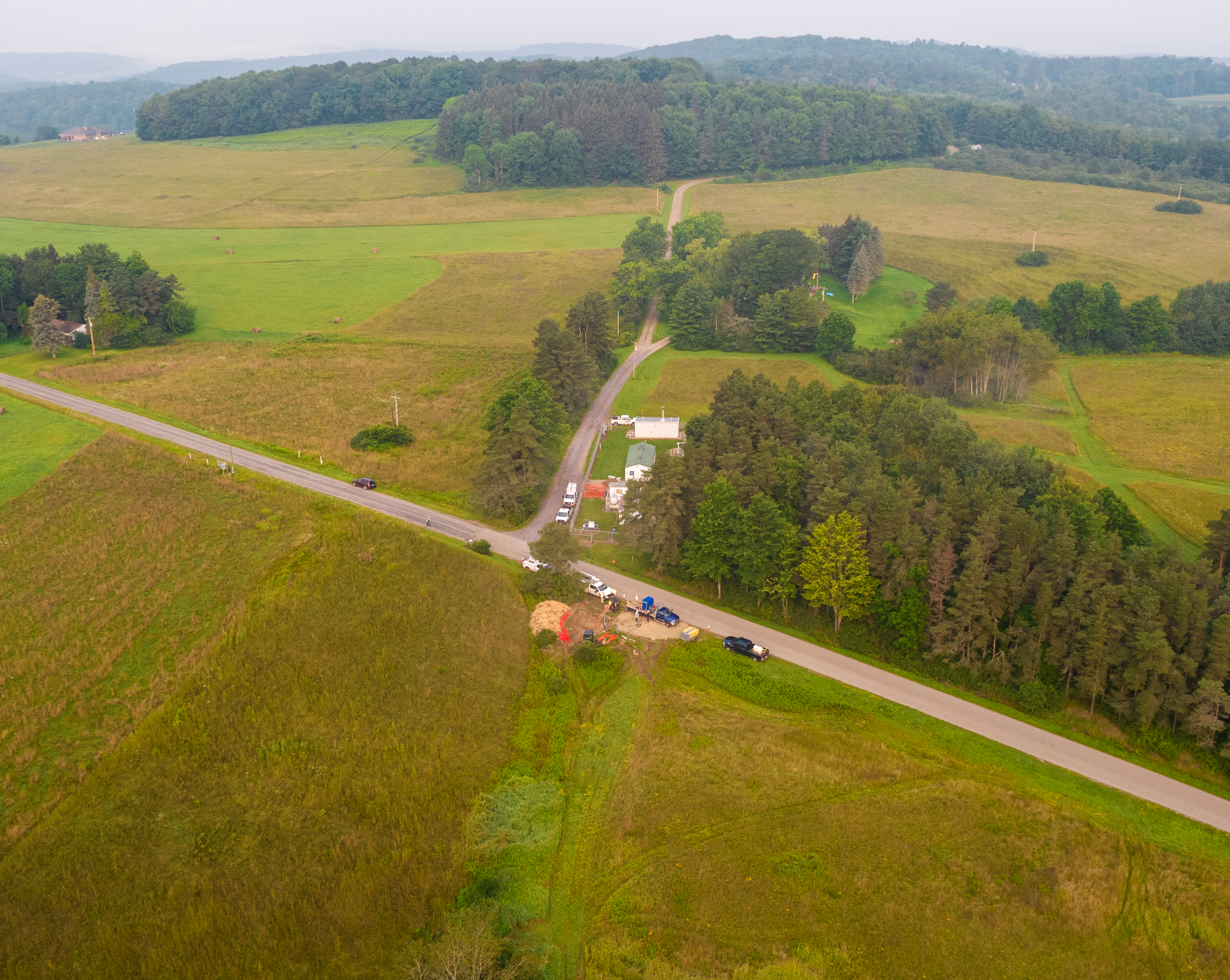 aerial shot of fields and a small worksite