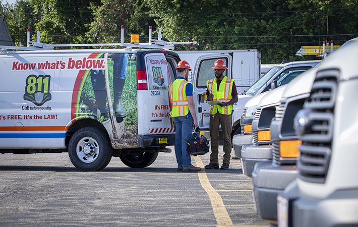 utility worker using flags to mark pipeline
